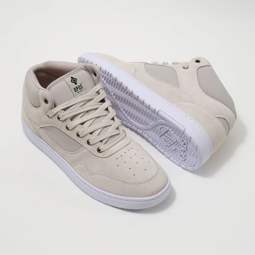 Pair of beige sneakers with white soles on a light gray background