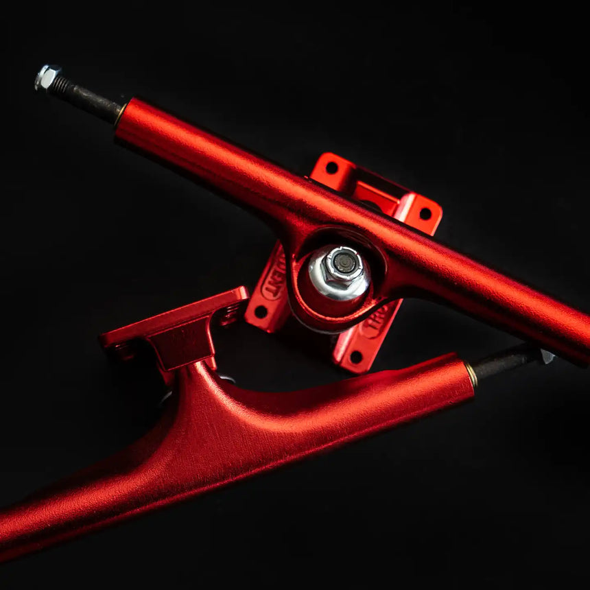 Red skateboard truck on a black background