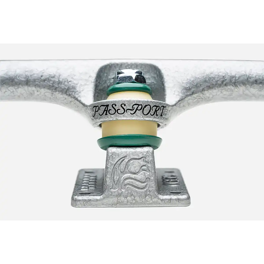 Close-up of a skateboard truck with 'PASS-PORT' branding on a white background