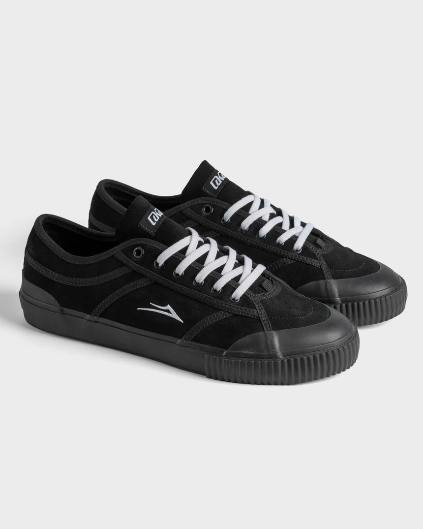 Black sneakers with white laces on a light gray background