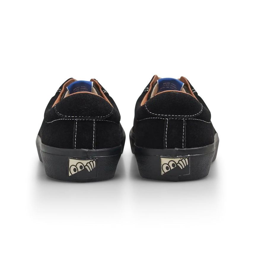 Black sneakers with a brand logo on the sole against a white background