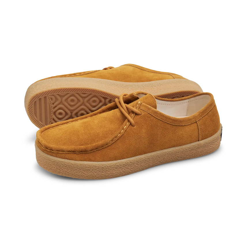 Pair of mustard yellow suede shoes on a white background