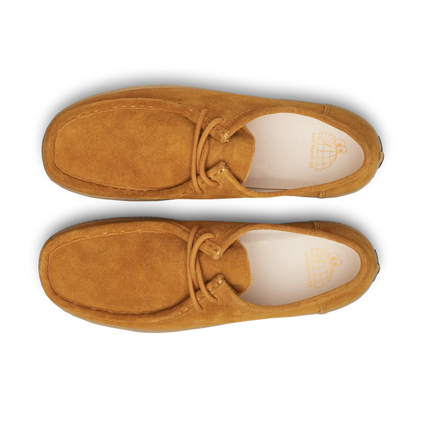 Pair of tan suede shoes on a white background