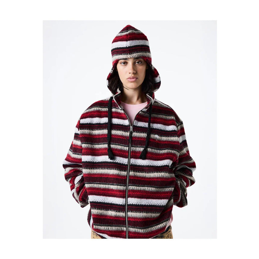 Person wearing a red and white striped hoodie and beanie on a white background