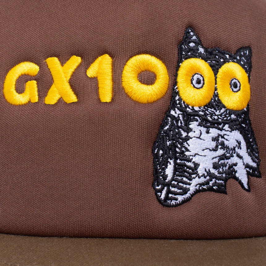 Brown fabric with 'GX10' in yellow and an embroidered owl design.