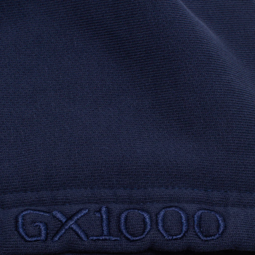 Close-up of a dark blue fabric with 'GX1000' embroidery.
