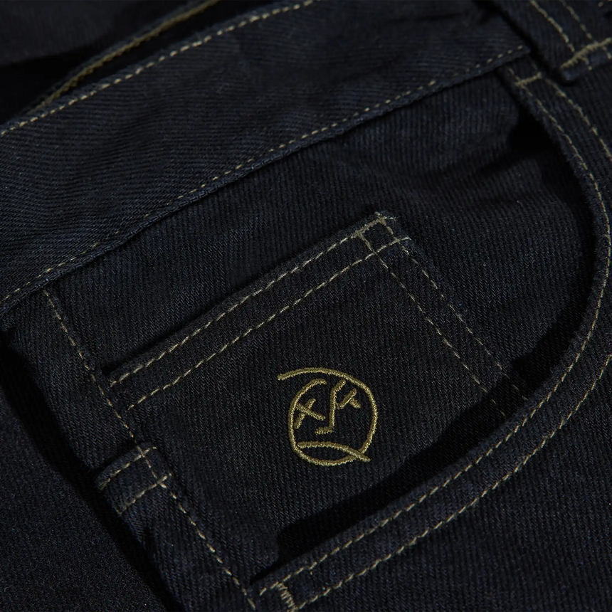 Close-up of a dark blue fabric with a logo on a pocket