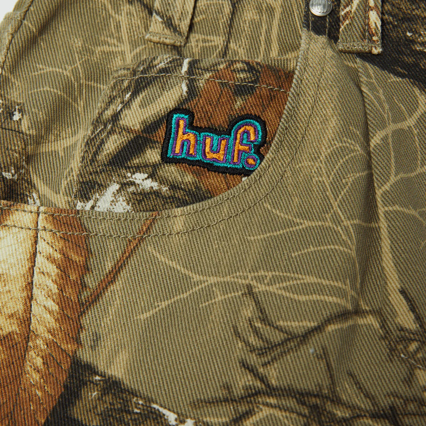 Camouflage jacket with a colorful 'huf.' logo patch.