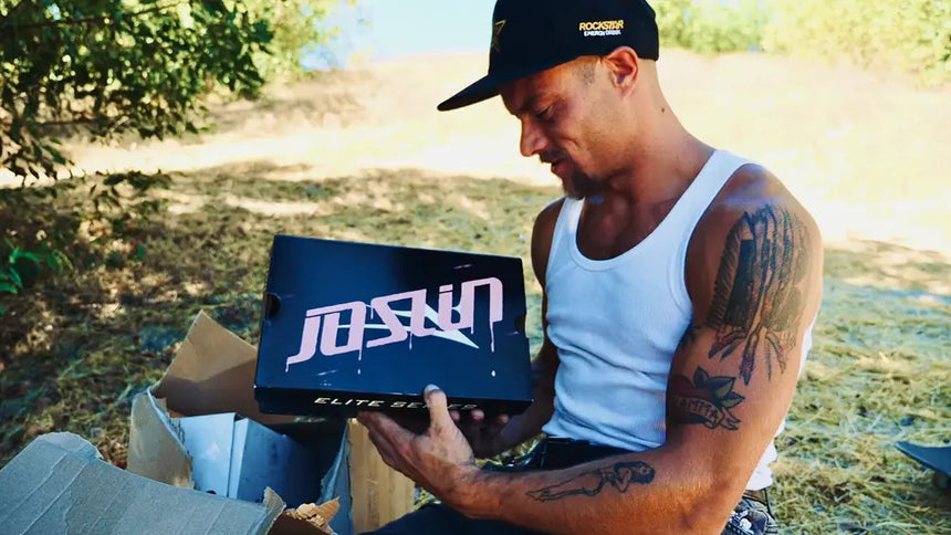 Man holding a box with 'JASON' branding outdoors