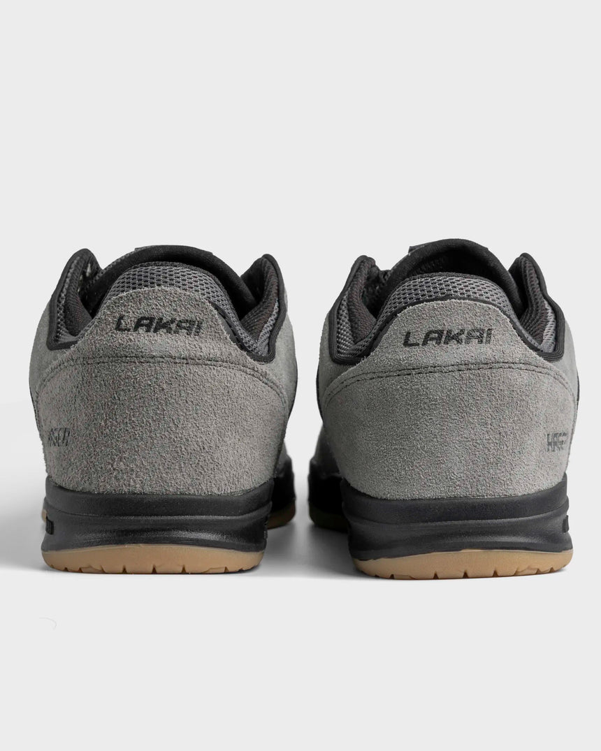 Gray sneakers with black soles on a white background