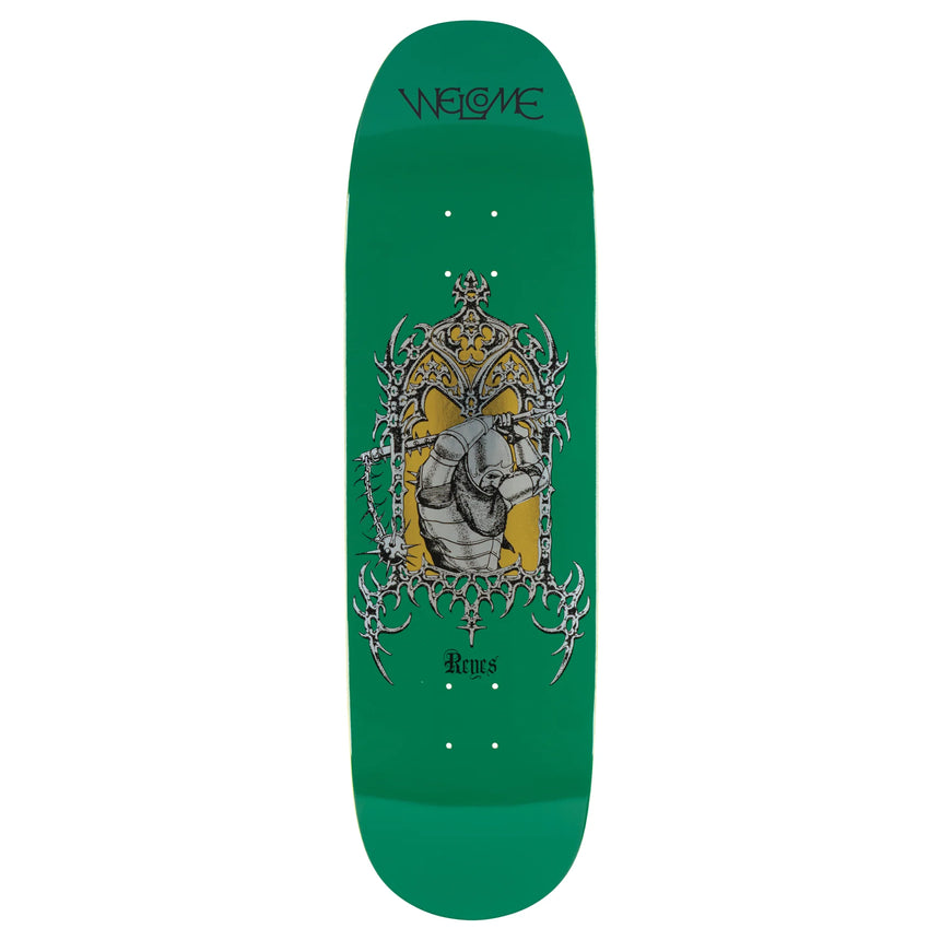 Green skateboard deck with a central graphic design on a white background