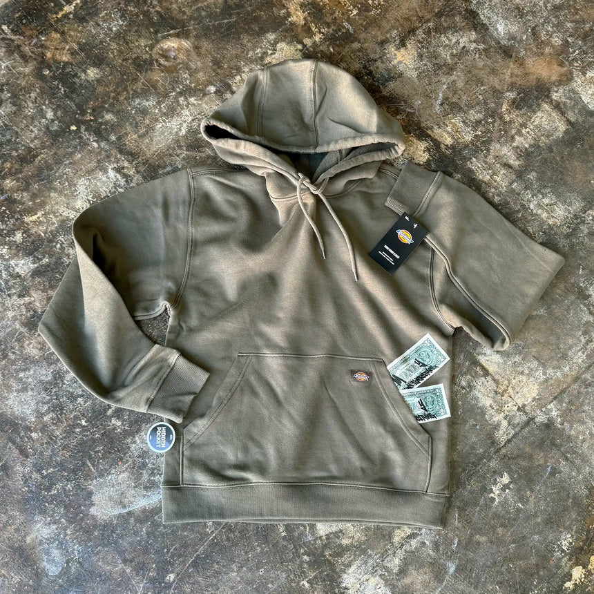 Green hoodie with tags on a textured surface