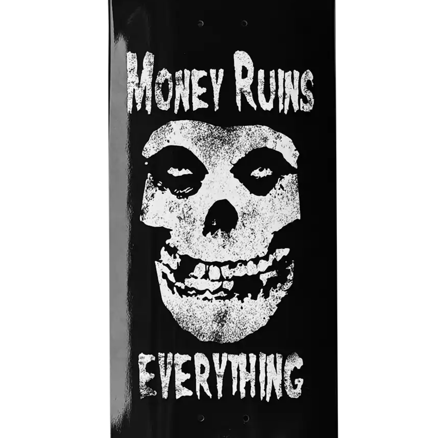 Skateboard deck with skull design and text 'Money Ruins Everything' on a black background