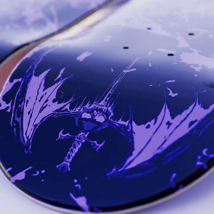 Close-up of a skateboard deck with a dark purple and black design on a white background