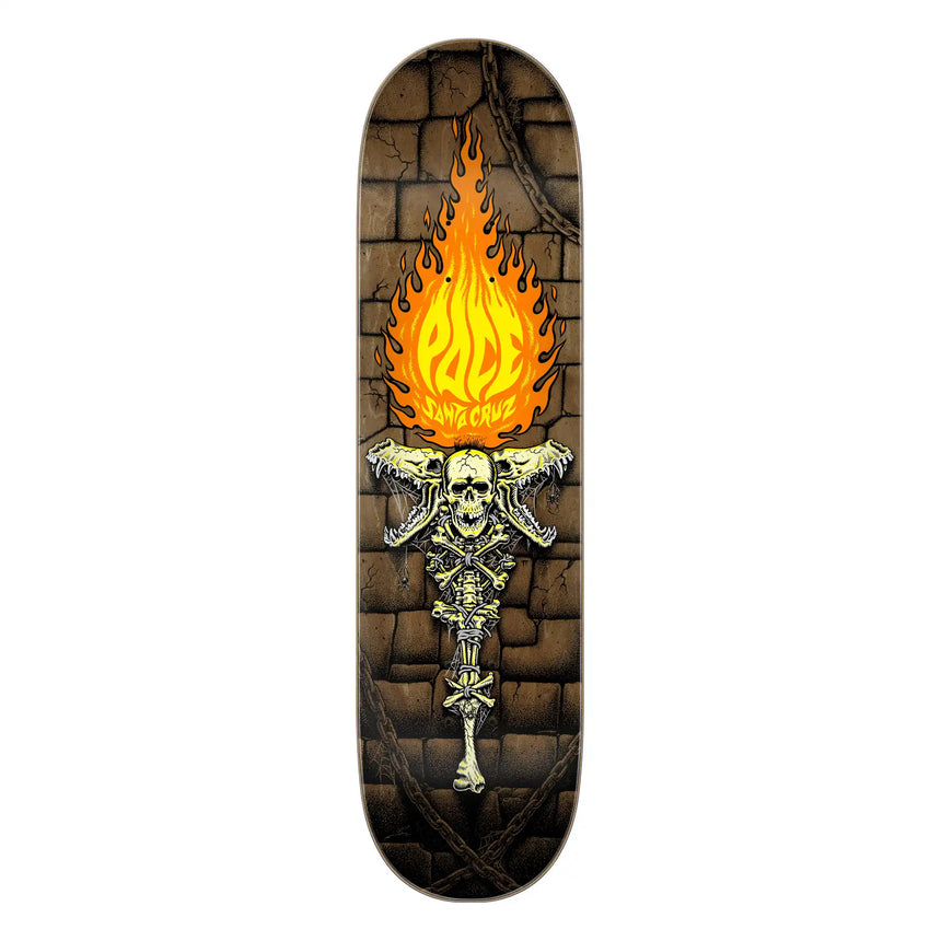 Skateboard deck with skull and flames design on a stone wall background