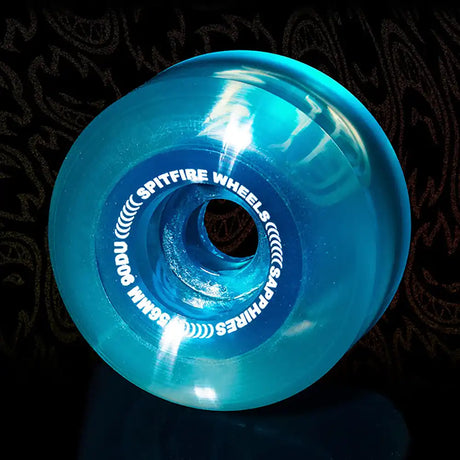 Blue Spitfire Wheels skateboard wheel on a dark background