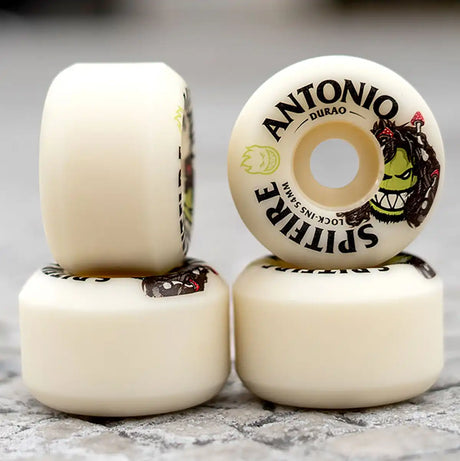 Four skateboard wheels with visible branding on a textured surface