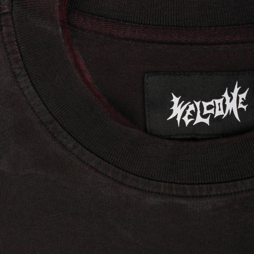 Black t-shirt with 'WELCOME' logo on a dark background
