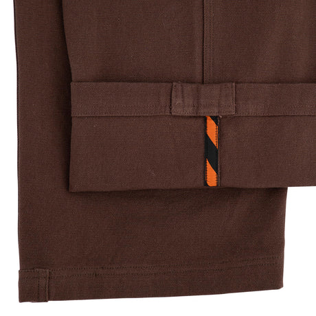 Brown jacket with a pocket and orange and black stripe on a white background