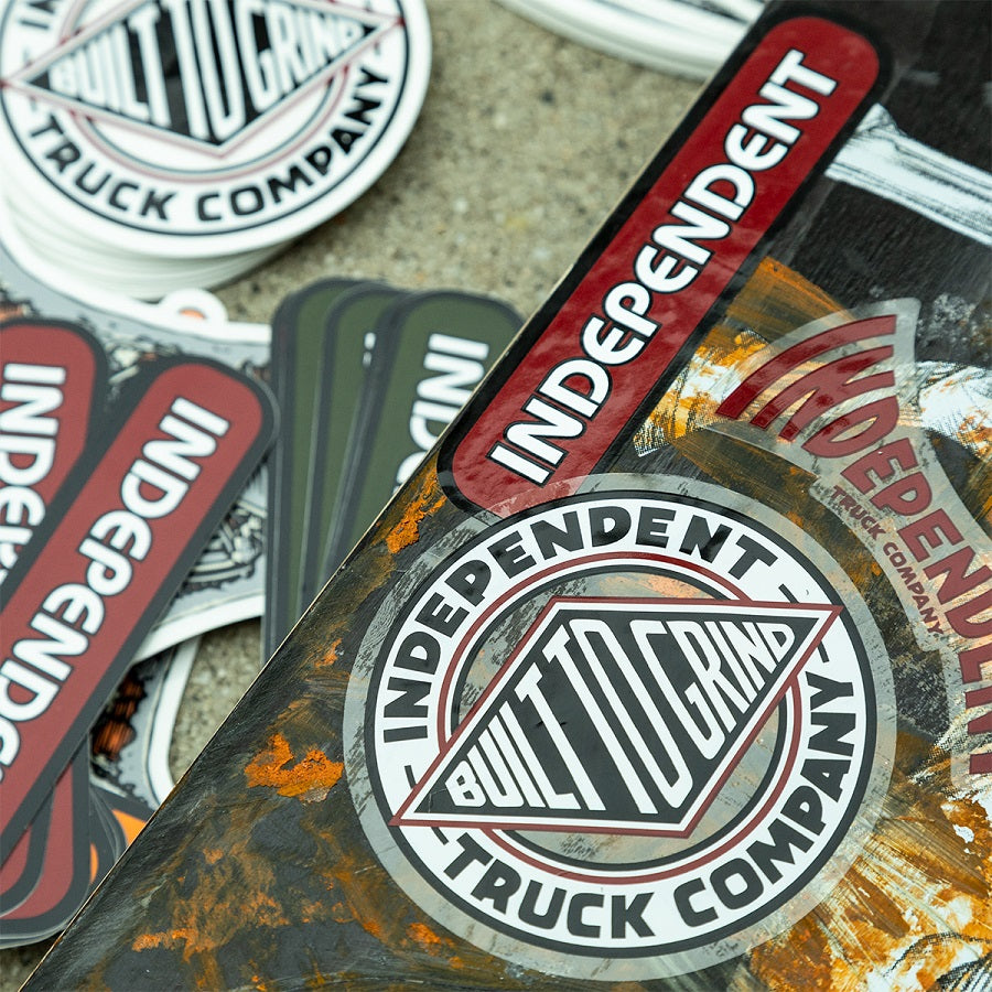 Collection of Independent and Built to Grind truck company stickers on a textured surface.