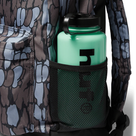Green water bottle with black cap in a pocket of camouflage-patterned clothing