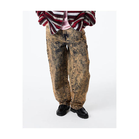 Person wearing distressed brown jeans and a plaid shirt on a white background