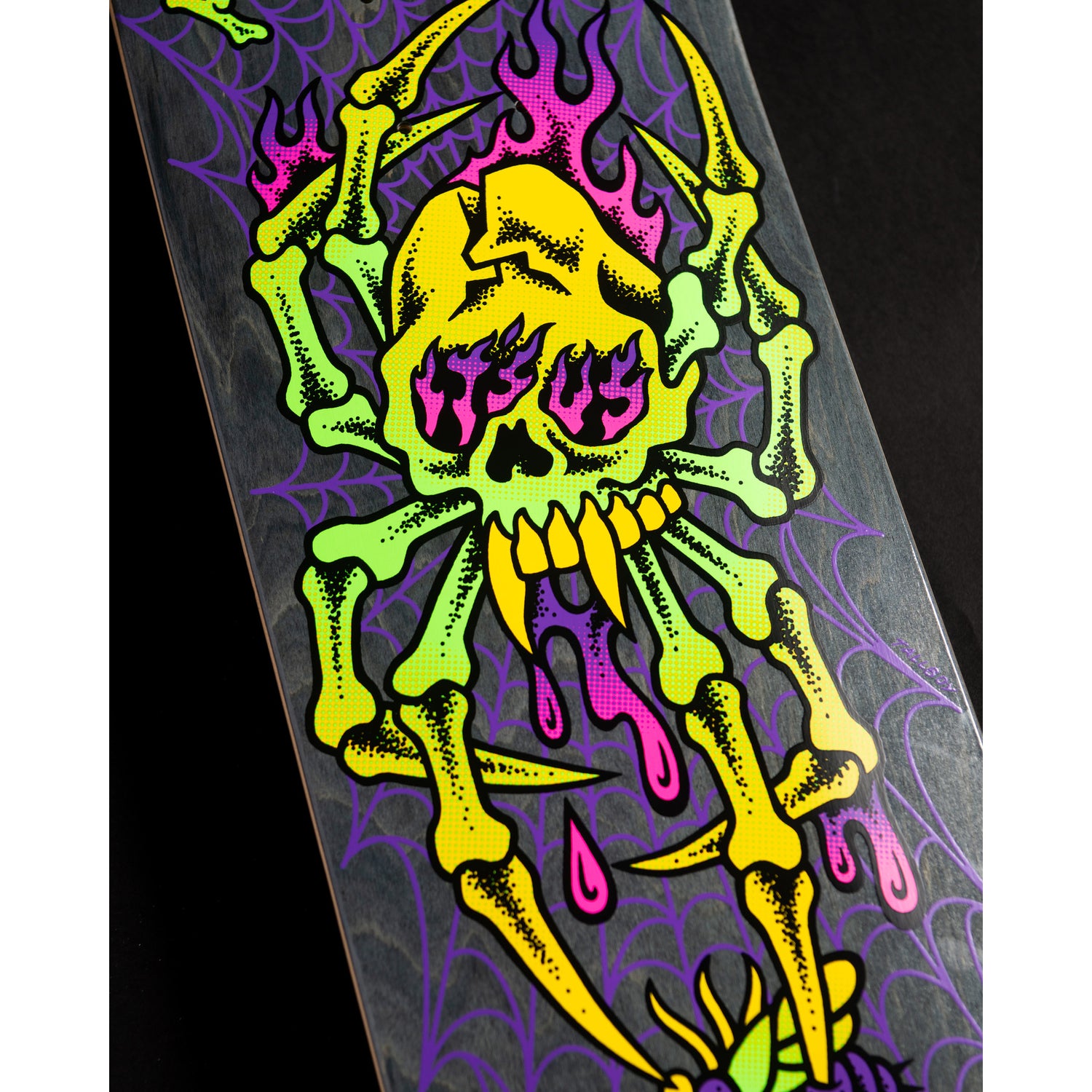 Skateboard deck with colorful skeleton design on a black background