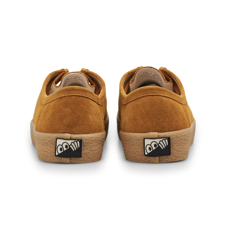 Pair of brown sneakers with a logo on the sole against a white background