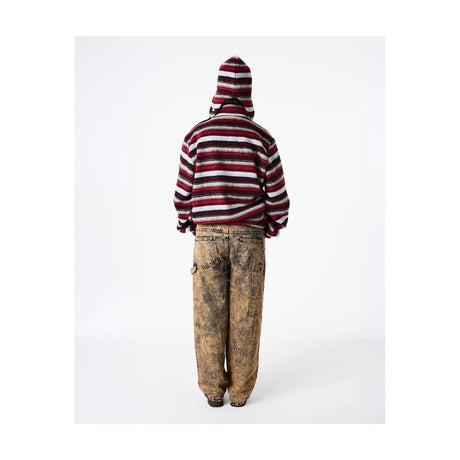 Person wearing a striped hoodie and dirty pants on a white background