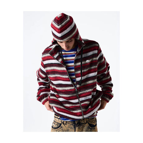 Person wearing a striped sweater and hat on a white background