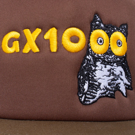 Brown fabric with 'GX10' in yellow and an embroidered owl design.