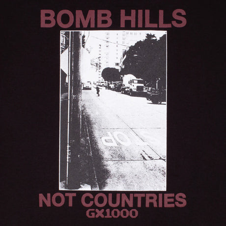 Album cover with black and white street scene and text 'Bomb Hills' and 'Not Countries GX1000' on a dark background.