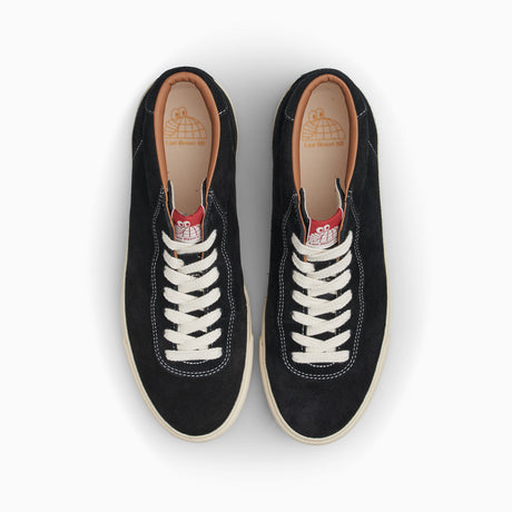 Pair of black sneakers with white laces on a white background