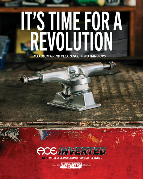Skateboard truck with 'It's Time for a Revolution' text and ACE Inverted branding on a worn surface.