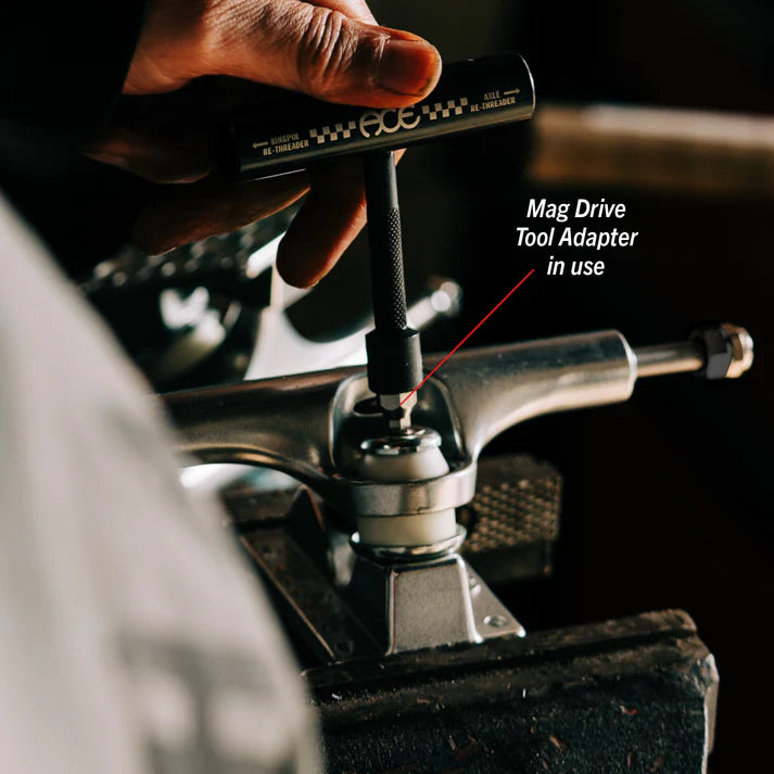 Hand using a Mag Drive Tool Adapter on a metal component with text overlay.