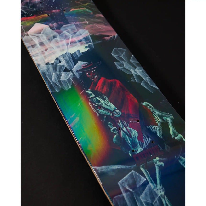 Skateboard deck with a colorful horse and rainbow design on a dark background