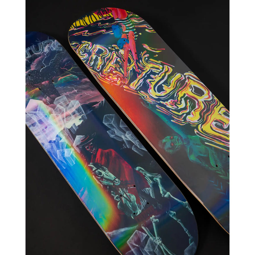 Two colorful skateboard decks with abstract designs on a black background