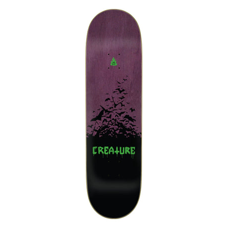 Skateboard deck with 'Creature' logo on a purple and black gradient background