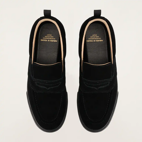 Pair of black loafers on a light gray background