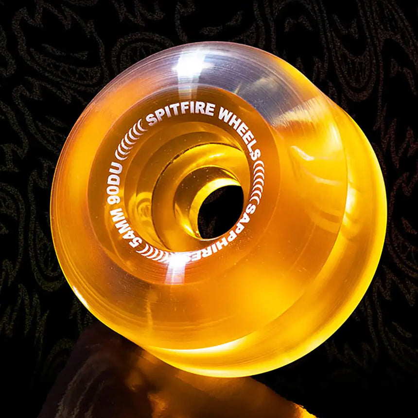 Orange Spitfire Wheels skateboard wheel on a dark background