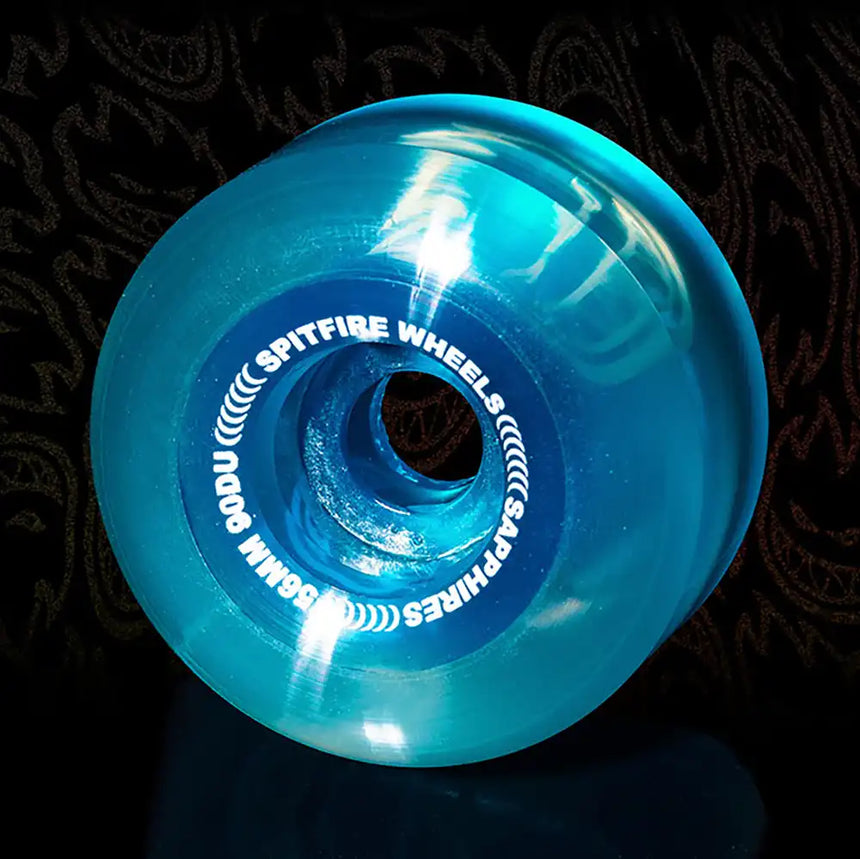 Blue Spitfire Wheels skateboard wheel on a dark background