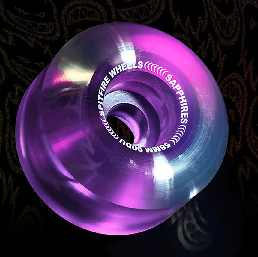 Purple and blue wheel with 'Spitfire Wheels' branding on a dark background