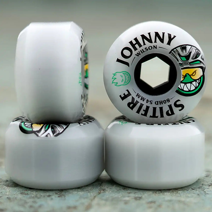 Skateboard wheels with 'Johnny Wilson Spitfire' branding on a neutral background