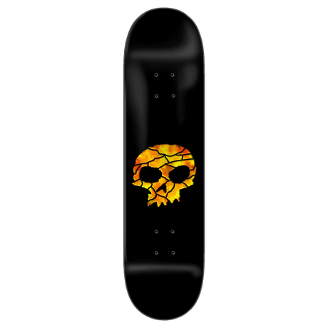 Black skateboard deck with a skull design in orange and yellow on a white background